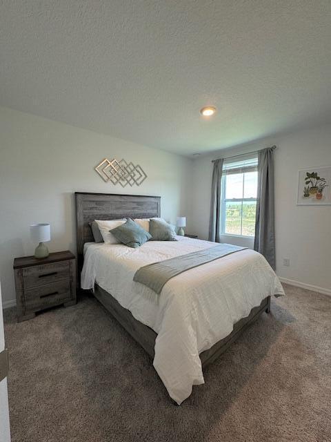 carpeted bedroom with a textured ceiling