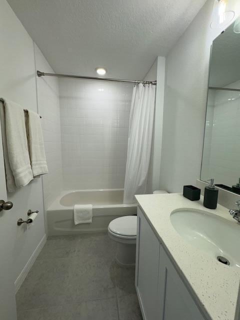 full bathroom with shower / tub combo, tile patterned floors, vanity, a textured ceiling, and toilet