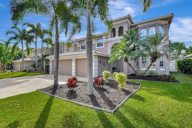 mediterranean / spanish-style house with a garage and a front lawn