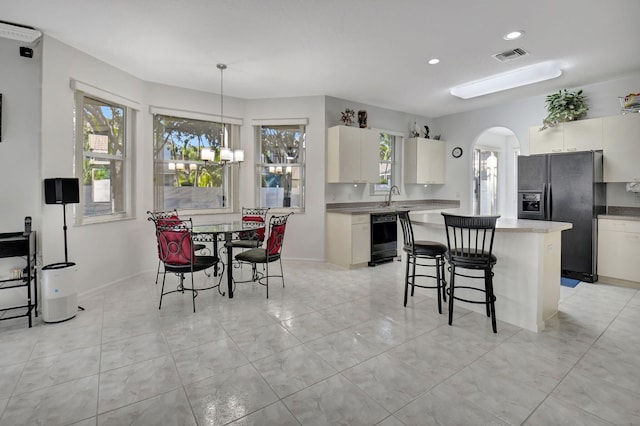 dining area with sink and a chandelier