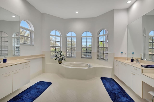 bathroom with a bathing tub, tile patterned flooring, and vanity