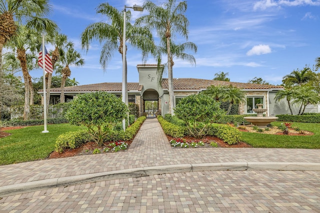 mediterranean / spanish house featuring a front yard