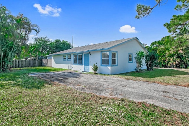 ranch-style home featuring a front yard