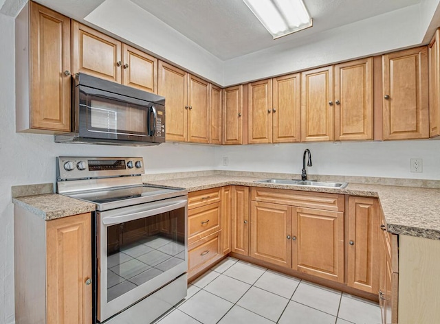 kitchen with light tile patterned floors, sink, and stainless steel electric range