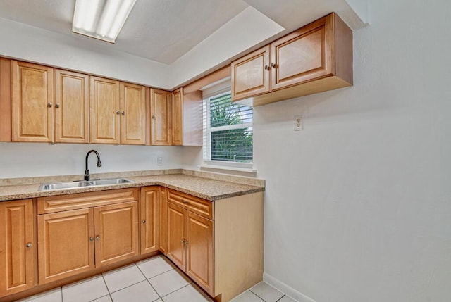 kitchen featuring sink and light tile patterned floors