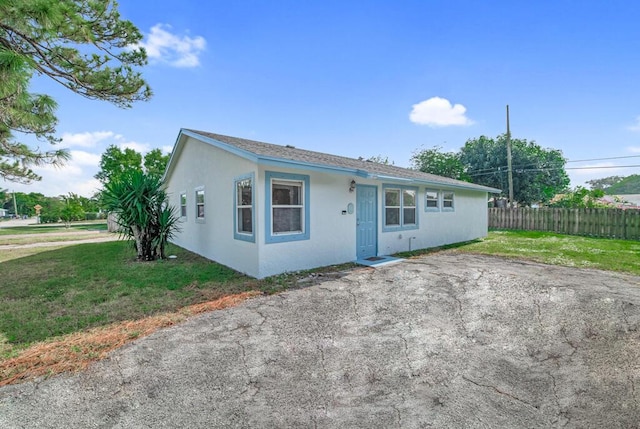 ranch-style house with a front lawn