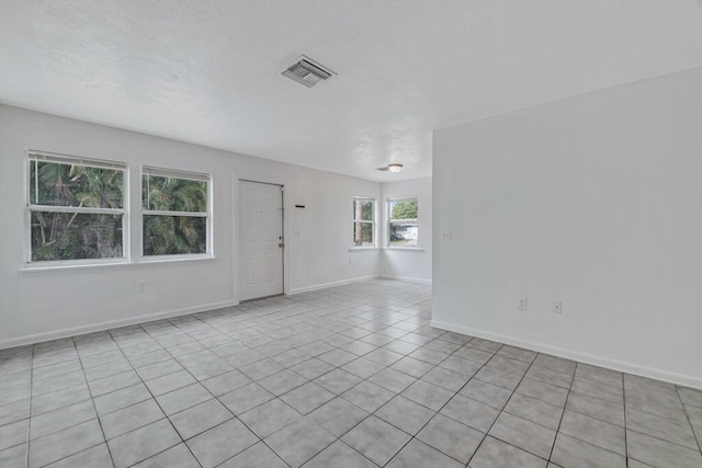 spare room with light tile patterned floors