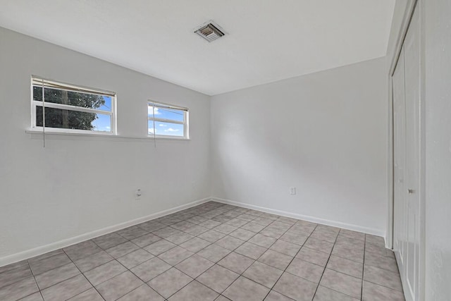 unfurnished room featuring light tile patterned floors