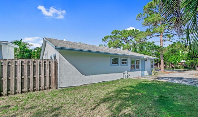 rear view of house featuring a lawn