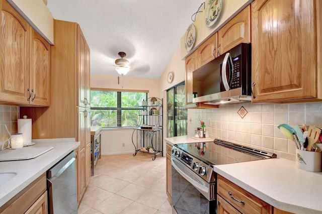 kitchen featuring light countertops, backsplash, appliances with stainless steel finishes, light tile patterned flooring, and ceiling fan