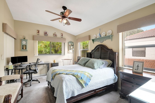 carpeted bedroom featuring multiple windows, vaulted ceiling, baseboards, and ceiling fan