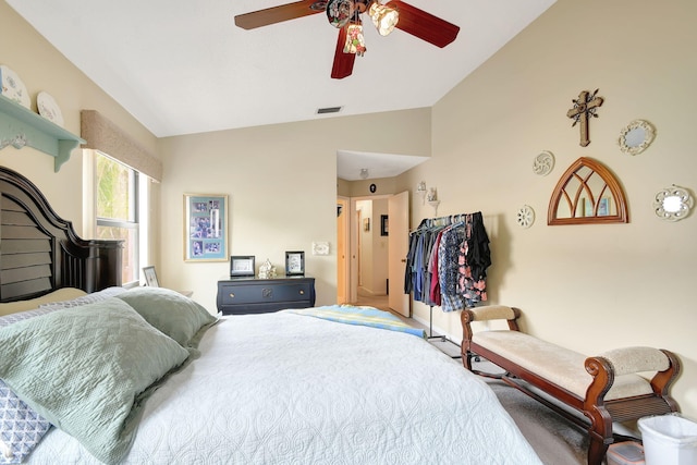 carpeted bedroom featuring a ceiling fan and vaulted ceiling