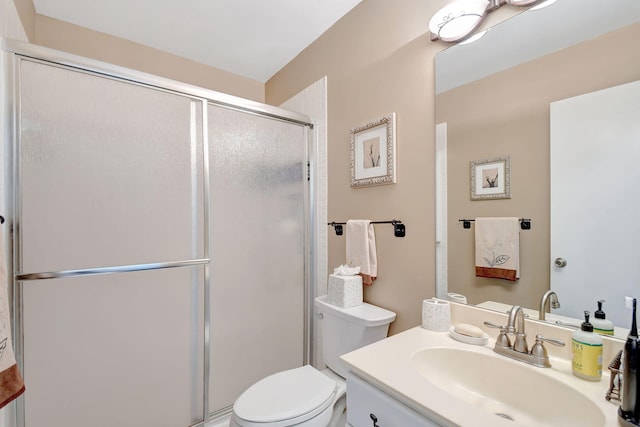 full bathroom with toilet, a shower stall, and vanity