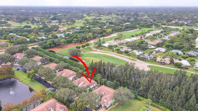 bird's eye view featuring golf course view, a water view, and a residential view