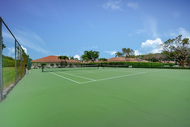 view of tennis court featuring fence