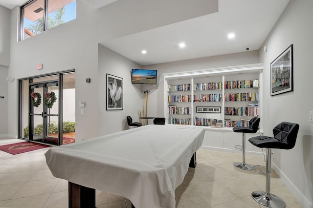 recreation room featuring light tile patterned floors, plenty of natural light, baseboards, and recessed lighting