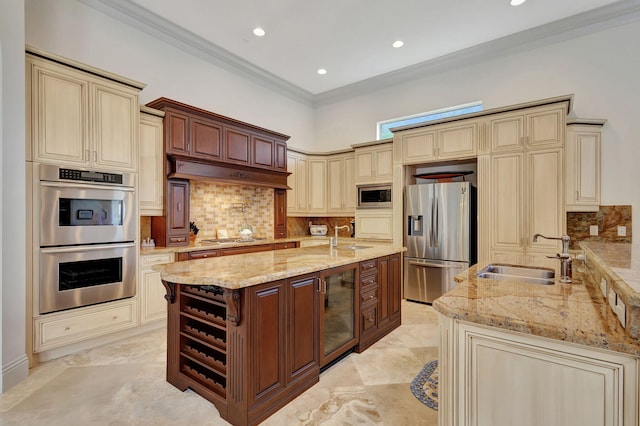 kitchen featuring light stone countertops, sink, appliances with stainless steel finishes, and cream cabinets