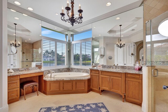 bathroom featuring tile patterned floors, vanity, a tray ceiling, a chandelier, and shower with separate bathtub