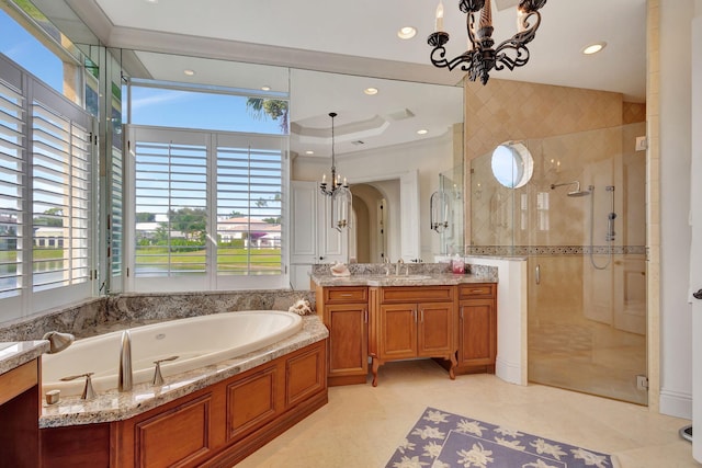 bathroom with separate shower and tub, vanity, and an inviting chandelier