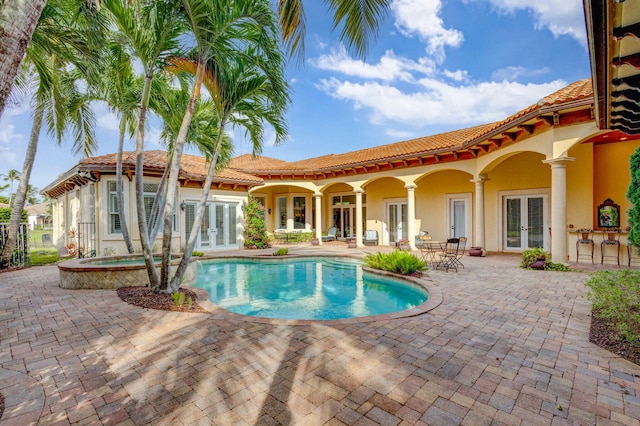 view of pool featuring a patio area, an in ground hot tub, and french doors