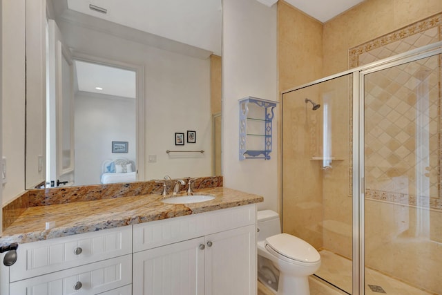 bathroom with vanity, an enclosed shower, and toilet