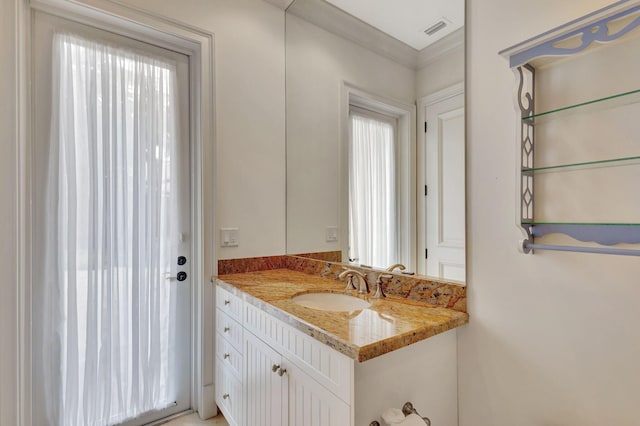 bathroom with vanity and crown molding