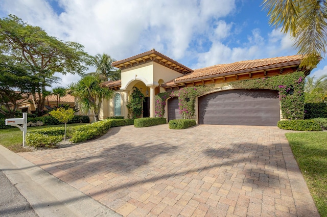 mediterranean / spanish home with a garage