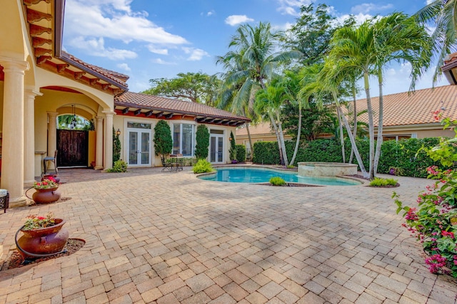 view of swimming pool featuring french doors and a patio