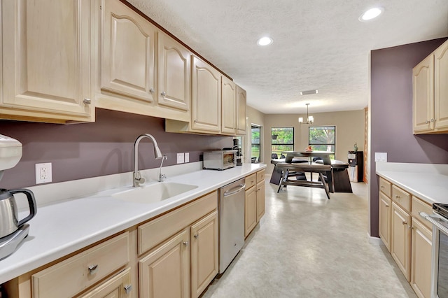 kitchen featuring a sink, stainless steel dishwasher, recessed lighting, and a textured ceiling