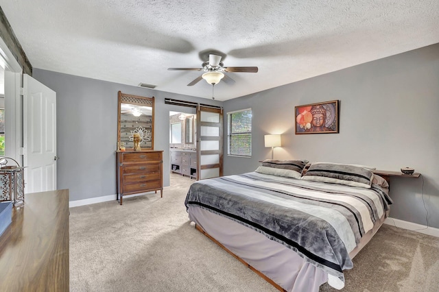 bedroom featuring a ceiling fan, baseboards, visible vents, and light carpet