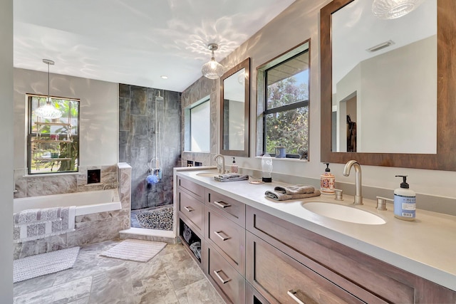 bathroom with vanity, a healthy amount of sunlight, and plus walk in shower