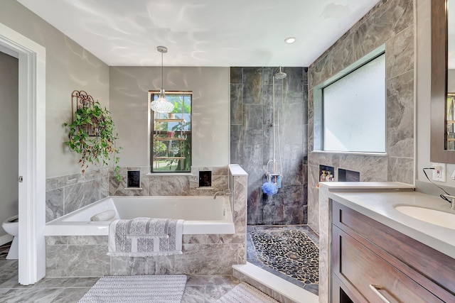 full bath featuring vanity, a garden tub, and tiled shower