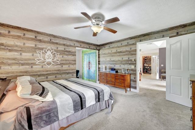 carpeted bedroom featuring a textured ceiling and a ceiling fan