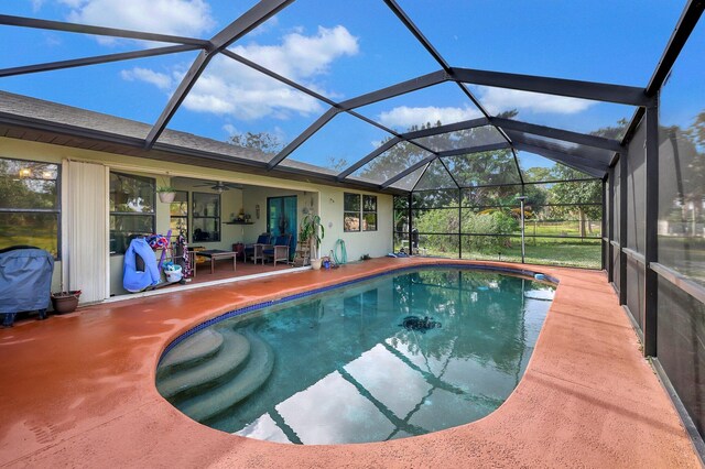 view of pool with glass enclosure