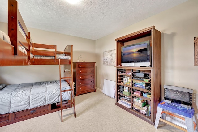 carpeted bedroom featuring a textured ceiling