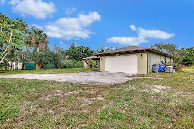 view of home's exterior featuring a garage, central AC unit, and a lawn