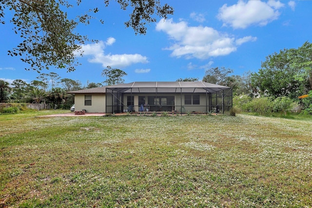 back of house featuring a lanai and a lawn