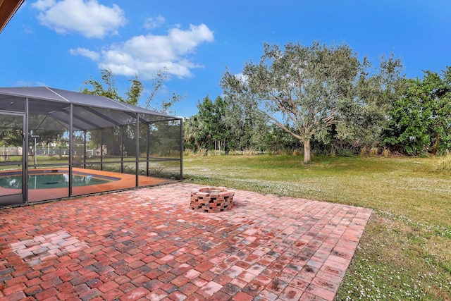 view of patio / terrace with a lanai and an outdoor fire pit