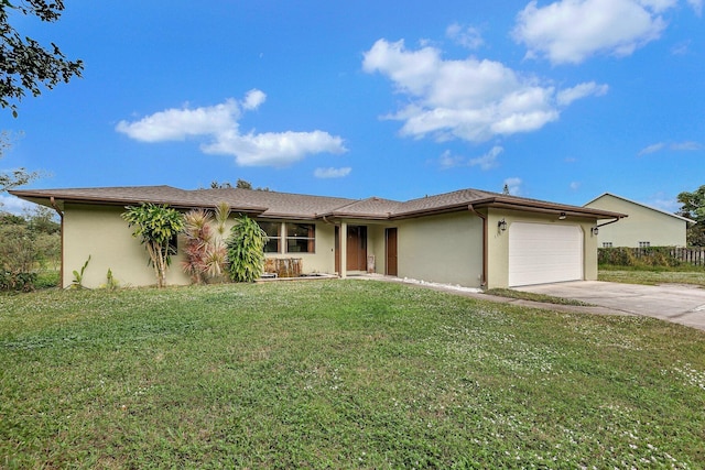 view of front of property featuring a front yard, an attached garage, concrete driveway, and stucco siding