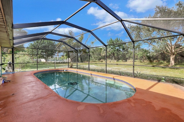 outdoor pool with a patio area and glass enclosure