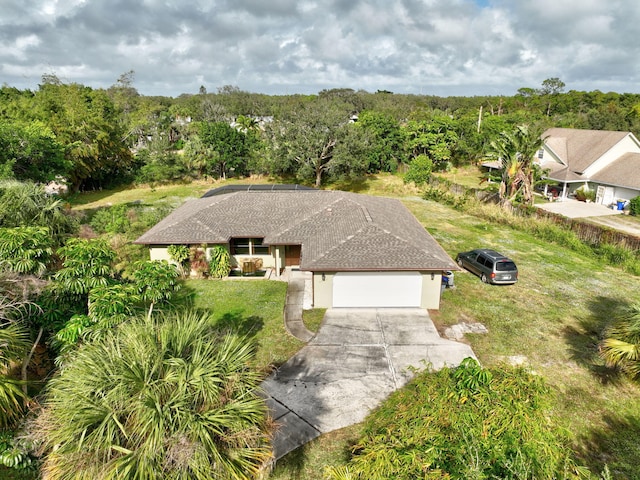 birds eye view of property featuring a wooded view