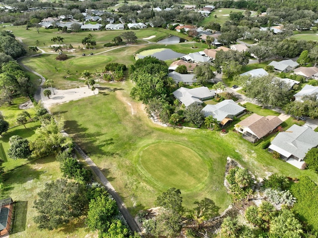 drone / aerial view with a residential view, a water view, and view of golf course