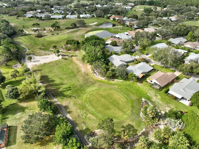 drone / aerial view with view of golf course and a residential view