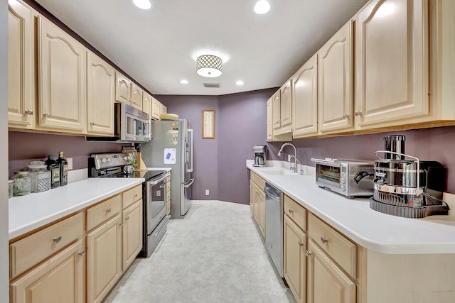 kitchen featuring light colored carpet, sink, and appliances with stainless steel finishes