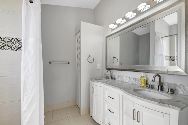 bathroom featuring tile patterned flooring and vanity