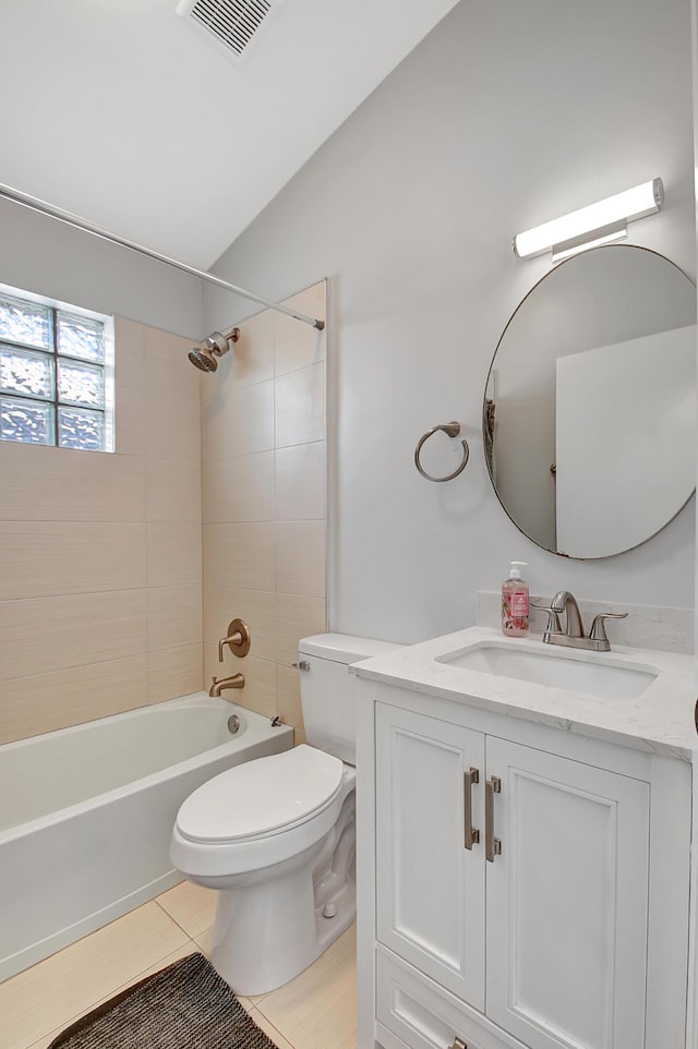 full bathroom with vanity, lofted ceiling, tile patterned flooring, tiled shower / bath combo, and toilet