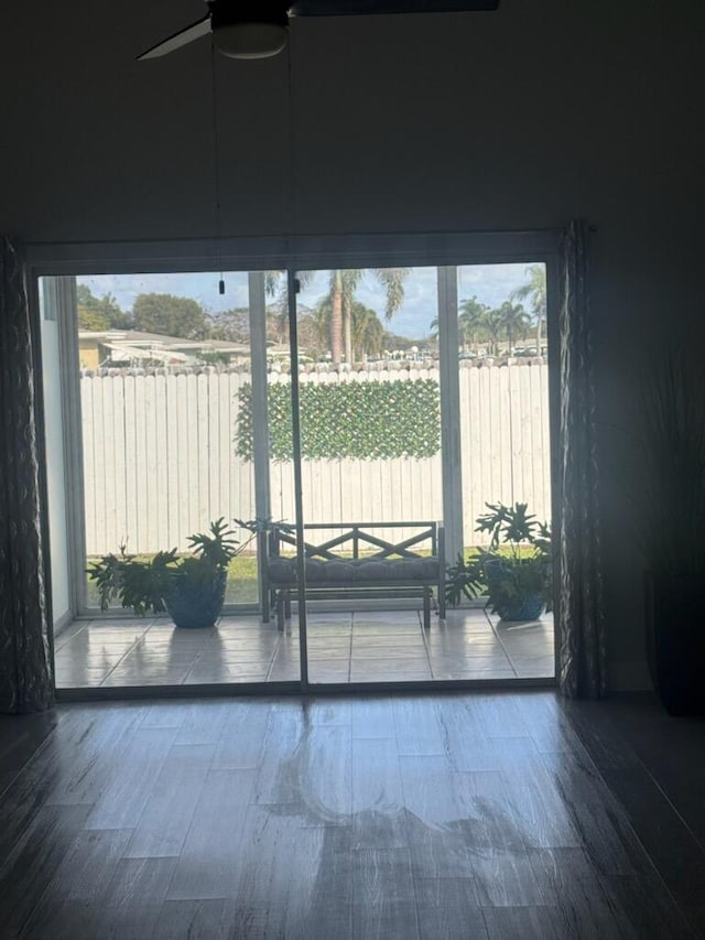 doorway featuring hardwood / wood-style flooring and ceiling fan