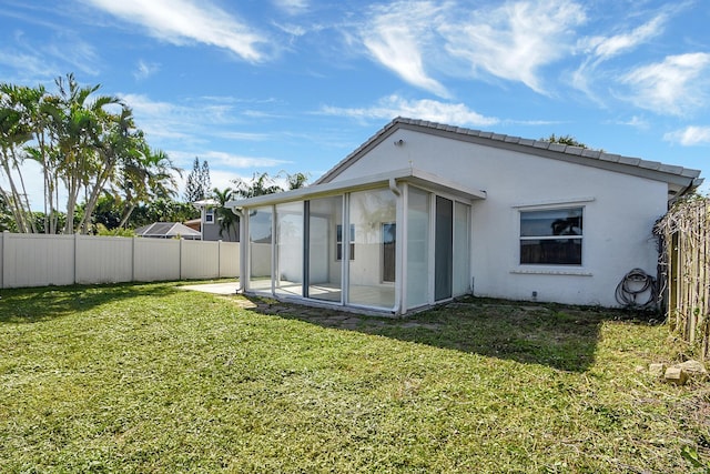 back of house featuring a lawn