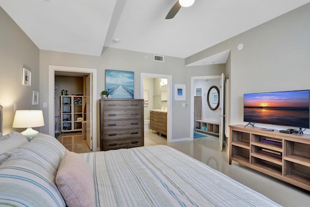 bedroom featuring connected bathroom, a spacious closet, and ceiling fan