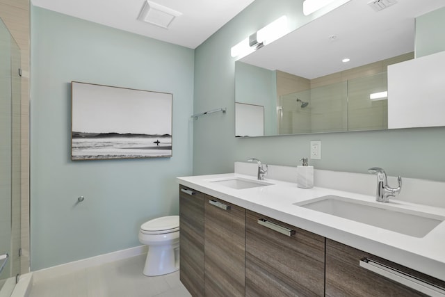 bathroom with tile patterned flooring, vanity, toilet, and a shower with door